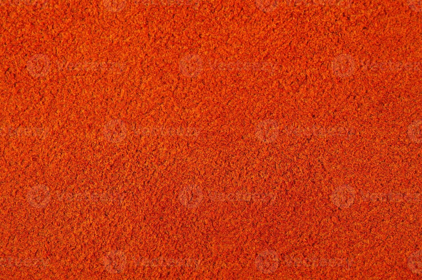 Warm red or orange suede as a background. photo