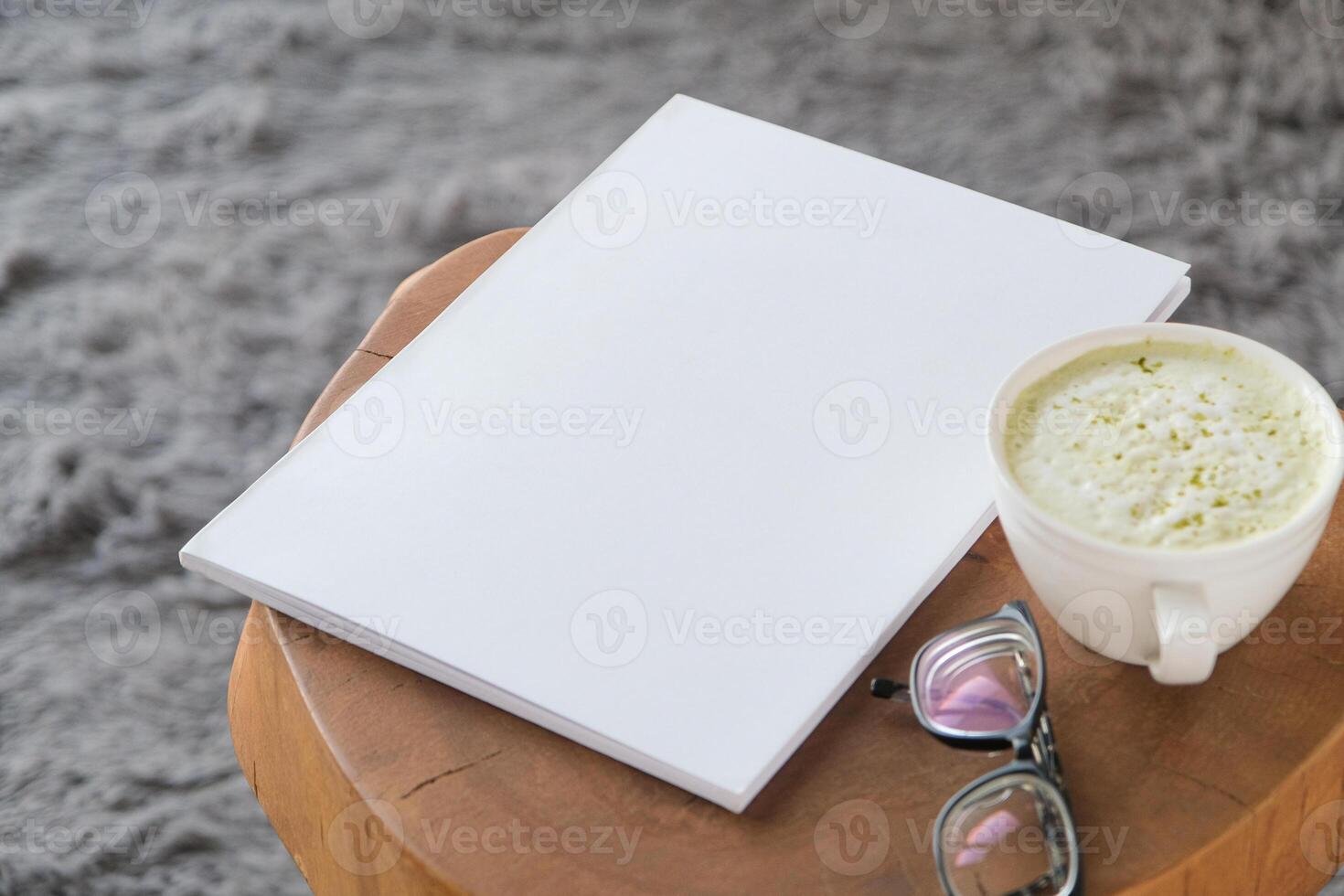 blank A4 magazine mockup on coffee table with green matcha latte photo