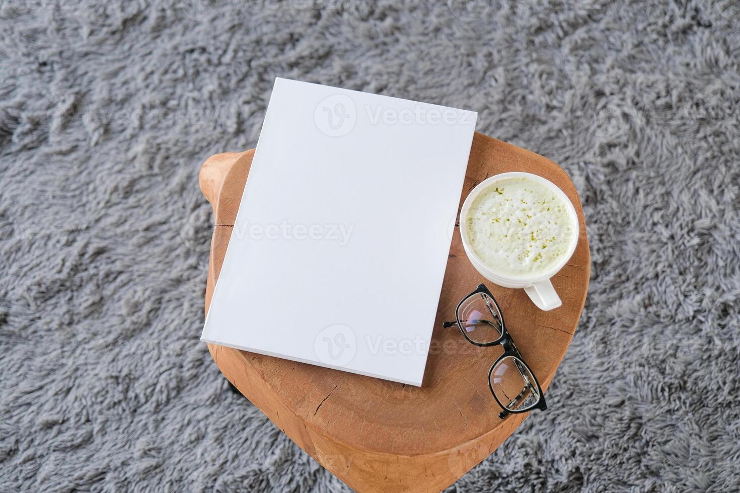 blank A4 magazine mockup on wooden coffee table with green matcha latte photo