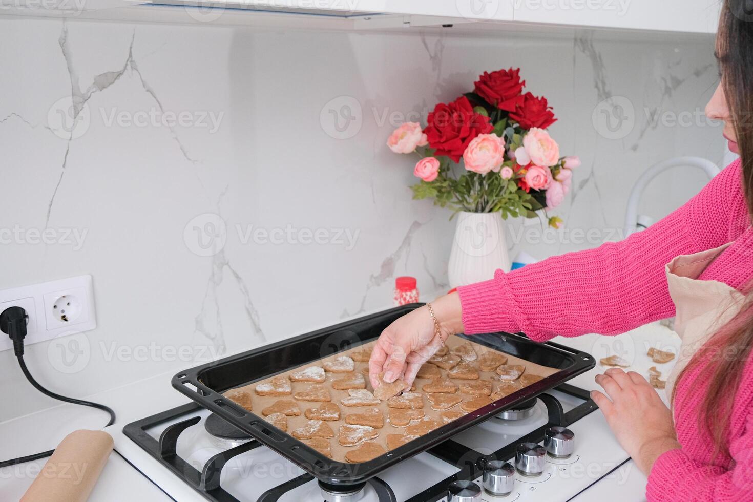 woman making heart shaped cookies in the decorated kitchen oprated kitchen photo
