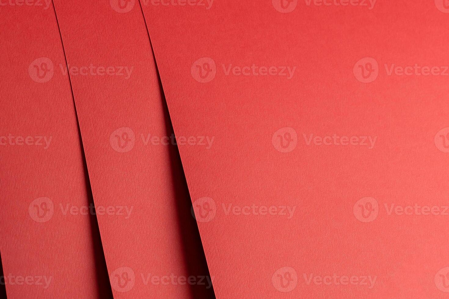 Red paper background with a matte texture. Ruby and crimson hues create a stylish, elegant, and photo