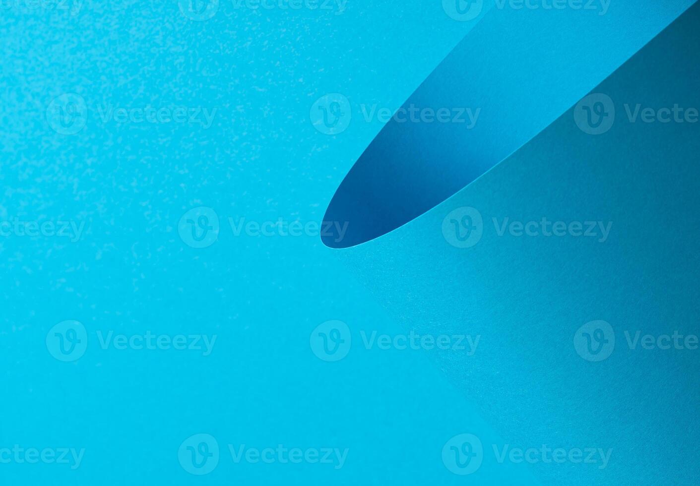 Blue paper background with a smooth matte finish and layered geometric accents. Vibrant pastel tones photo