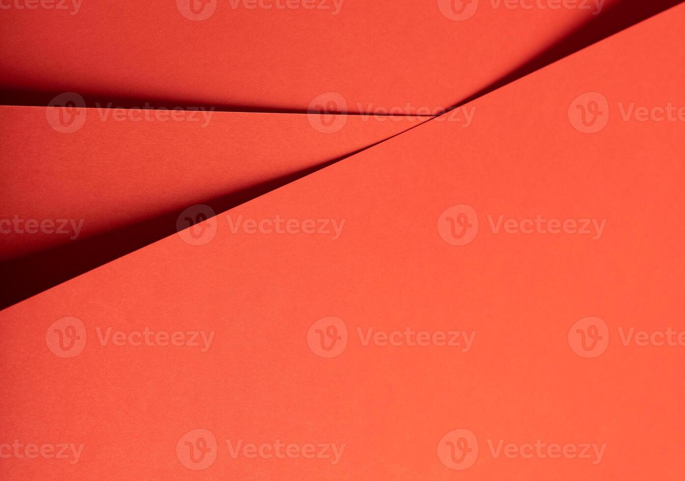 Fiesta red and orange paper background with a matte finish and intersecting, smooth layers. Vibrant, photo
