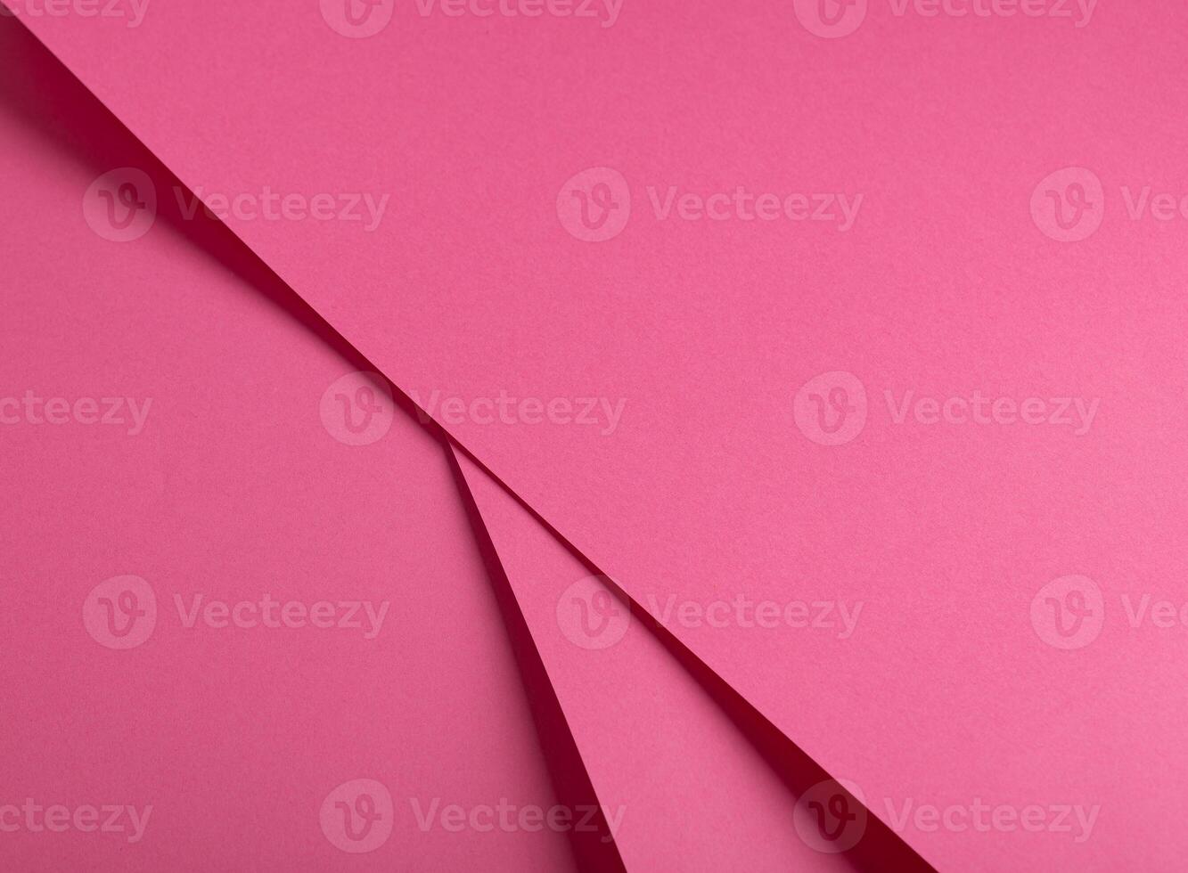 Pink yarrow paper background with a smooth matte finish and bent metallic accents. Vibrant, soft photo