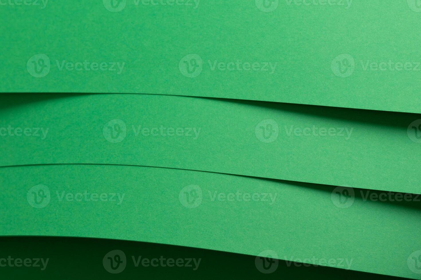 Eden green paper background with layered, curved sheets and a smooth matte finish. Vibrant, soft photo