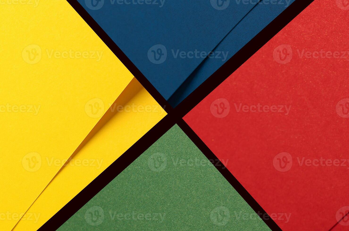 Bold geometric paper background divided into vibrant quadrants of yellow, blue, red, and green. photo