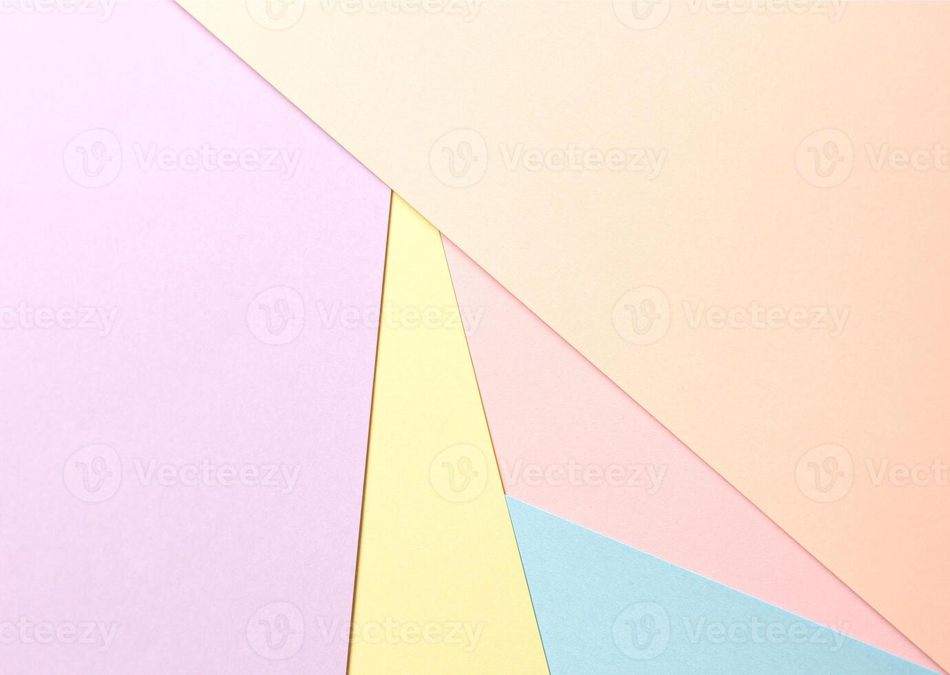 Pastel abstract geometric paper background featuring peach, lavender, yellow, pink, and blue in a photo
