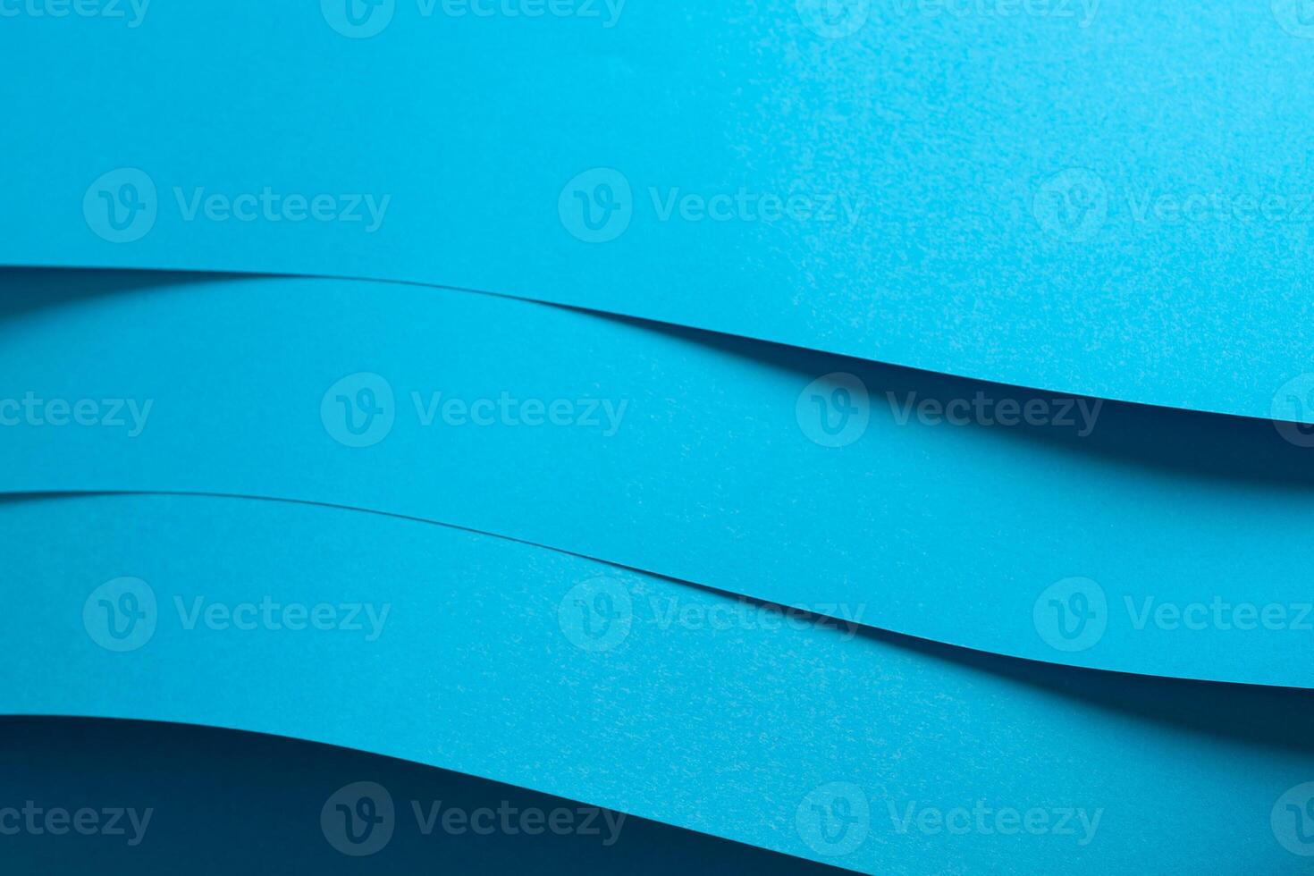 Blue paper background with a smooth matte finish and layered edges. Vibrant pastel tones and a photo