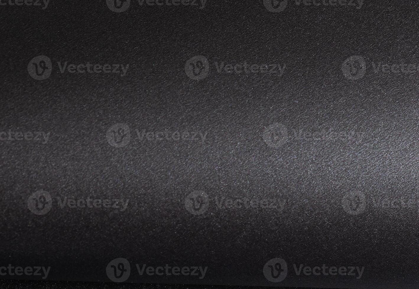 Elegant black paper background with a smooth, textured surface, monochrome design creating a photo