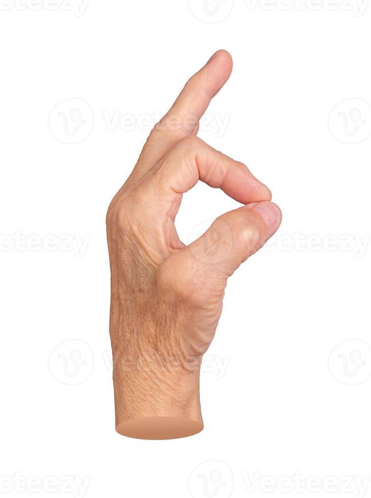 Elderly female hand making an OK gesture, symbolizing approval, positivity, and agreement. Wrinkled photo