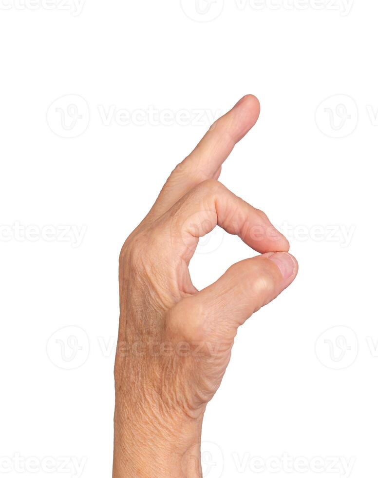 Elderly hand making OK gesture, thumb and finger forming a circle, symbolizing approval, success, photo