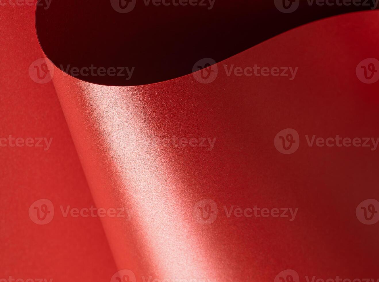 Shiny red paper with a glossy, luxurious surface and elegant sheen. Festive and textured background photo