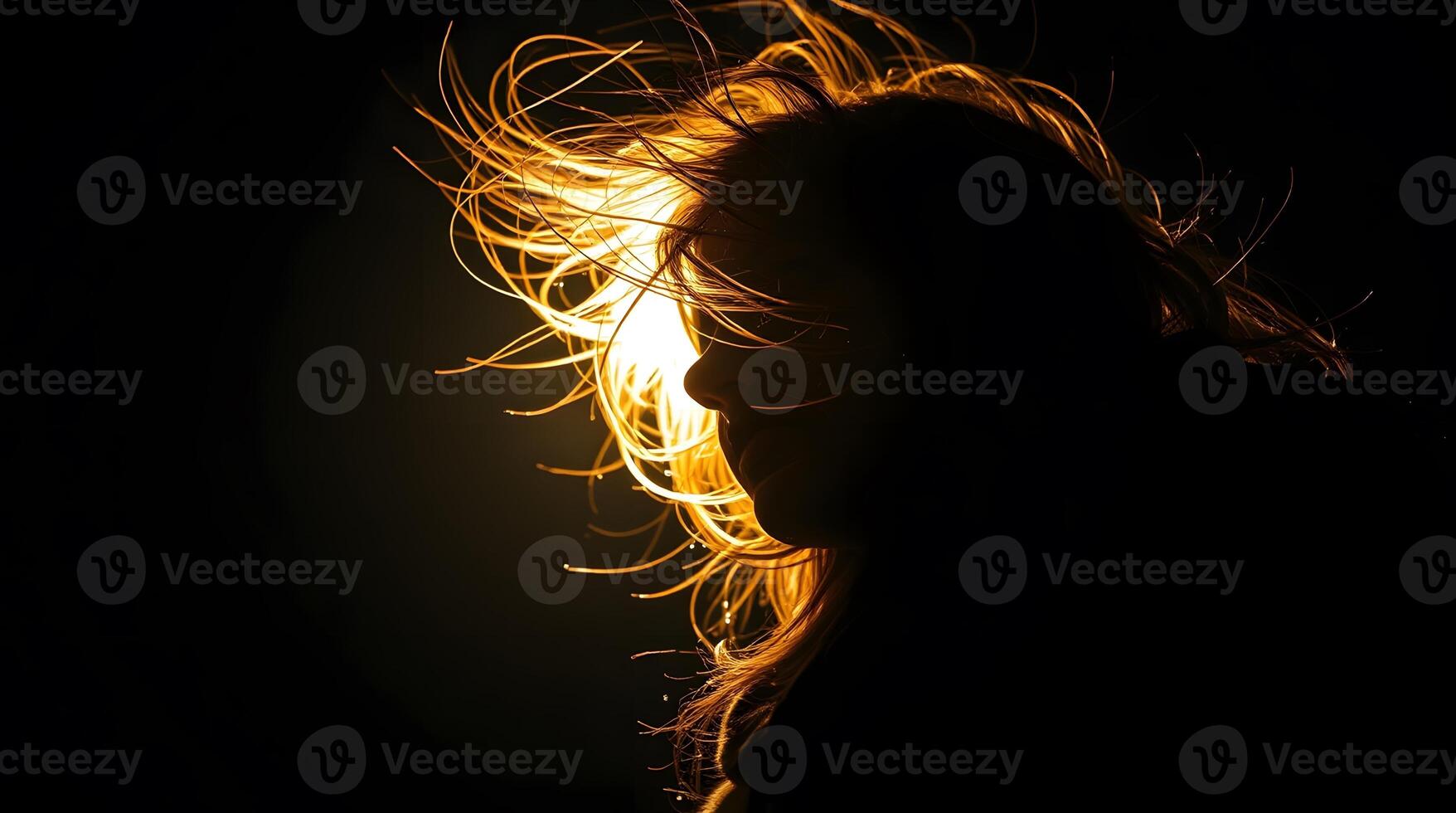 Silhouette of a Woman with Illuminated Hair photo