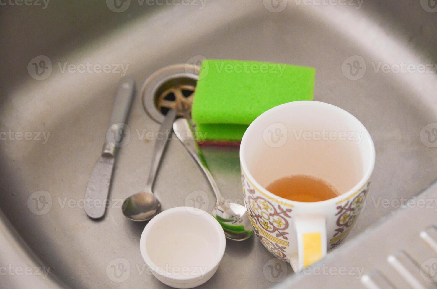 Dirty Dishes in Sink Kitchen Cleanup Concept photo