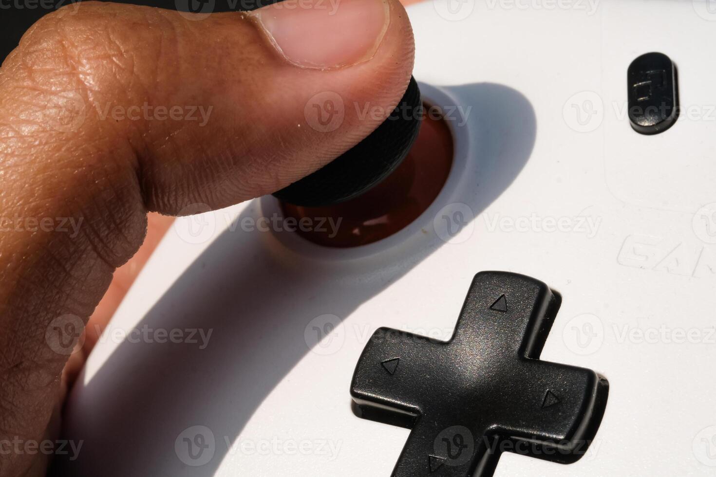 Pressing buttons on a white gamepad. The game controller buttons are set soft and ergonomic. Finger mechanics and Hobbies. Macrophotography Theme photo