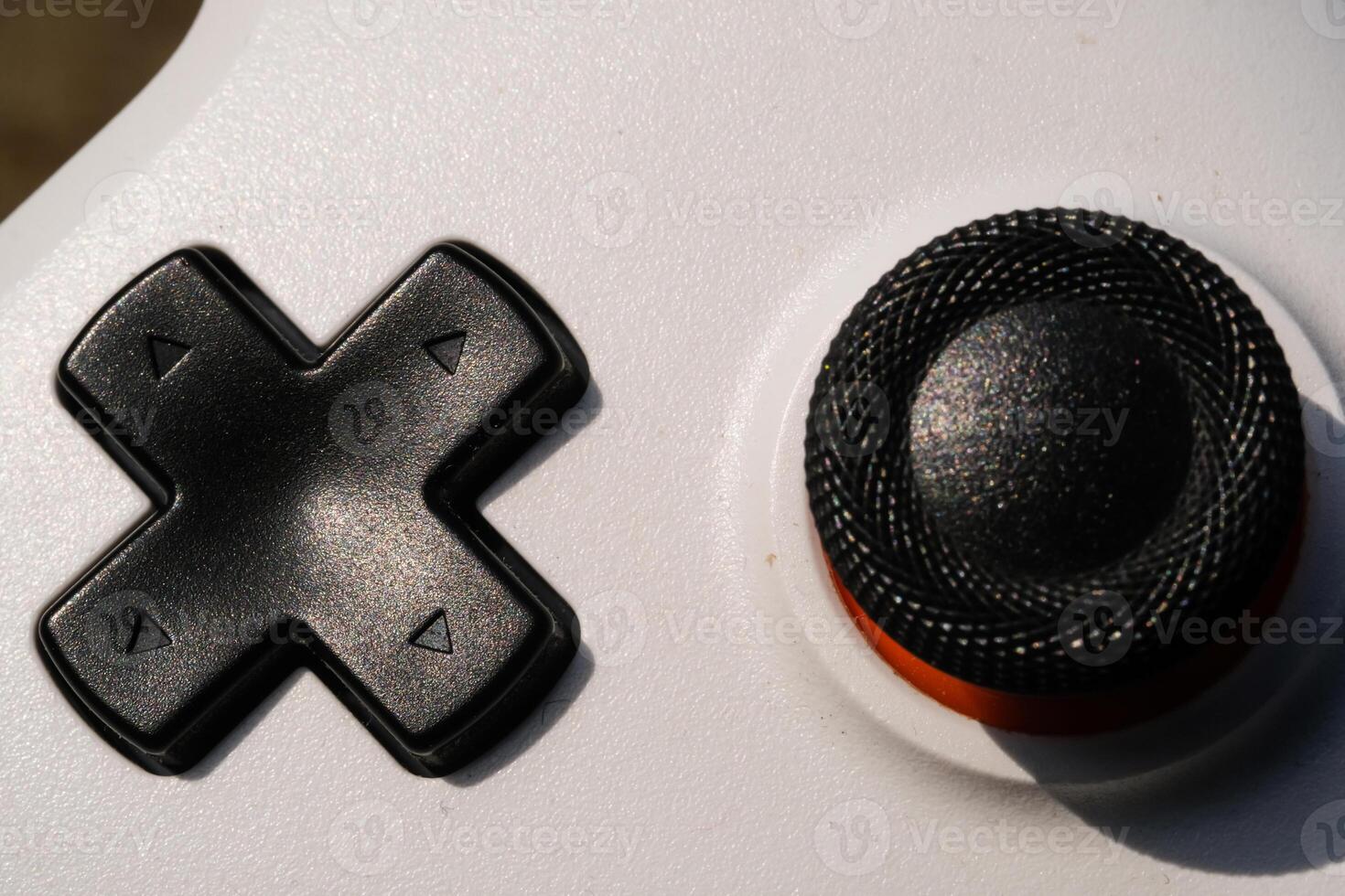 Black Directional Pad on a white Game controller. Directional pad is used to move focus up, down, right, and left in the user interface. Hobbies and leisures. Negative Space photo