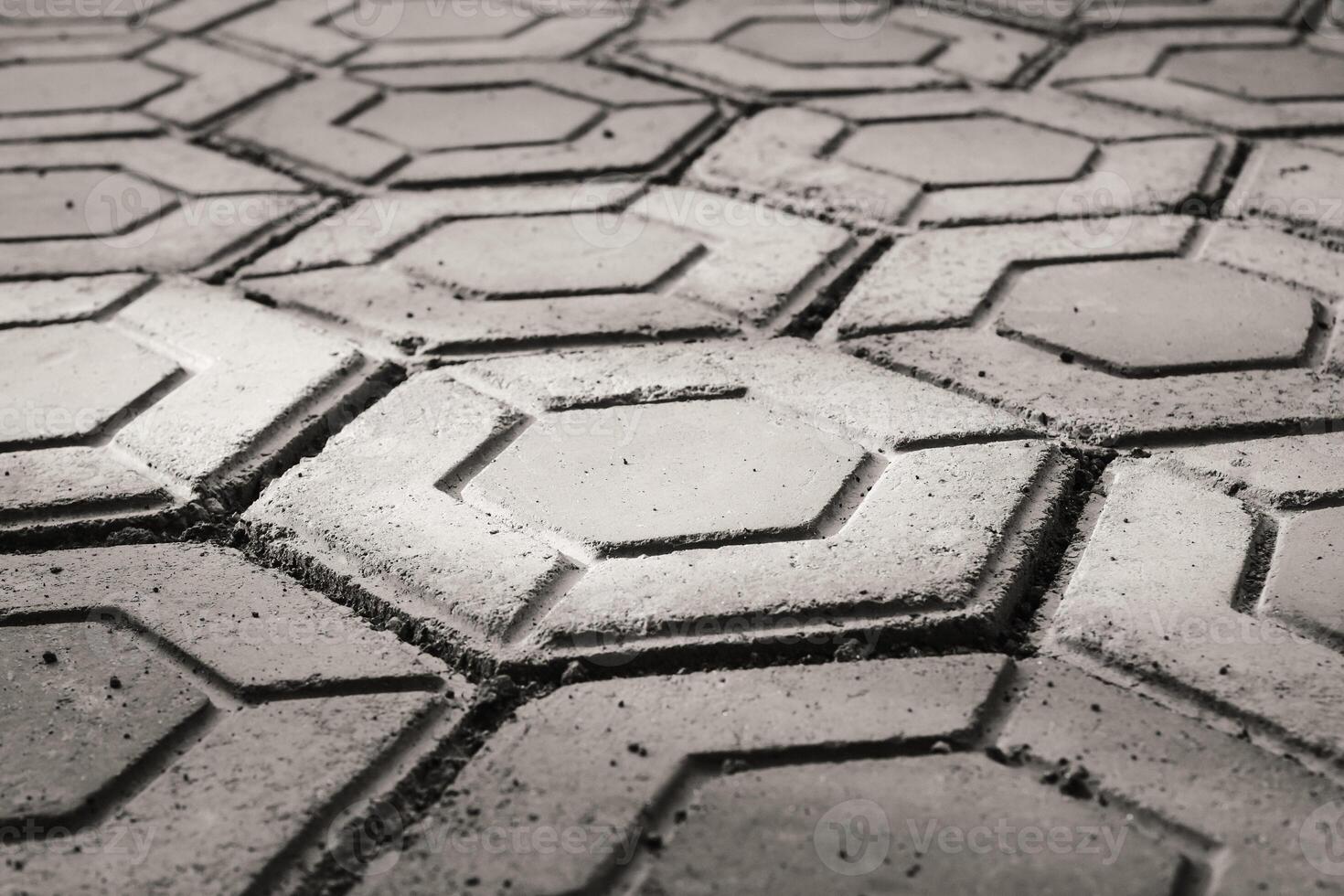 Closeup black and white hexagonal brick for flooring. Paving block backgrounds in monochrome color. Texture and Details. Bricks and blocks are made from cement. Negative Space photo