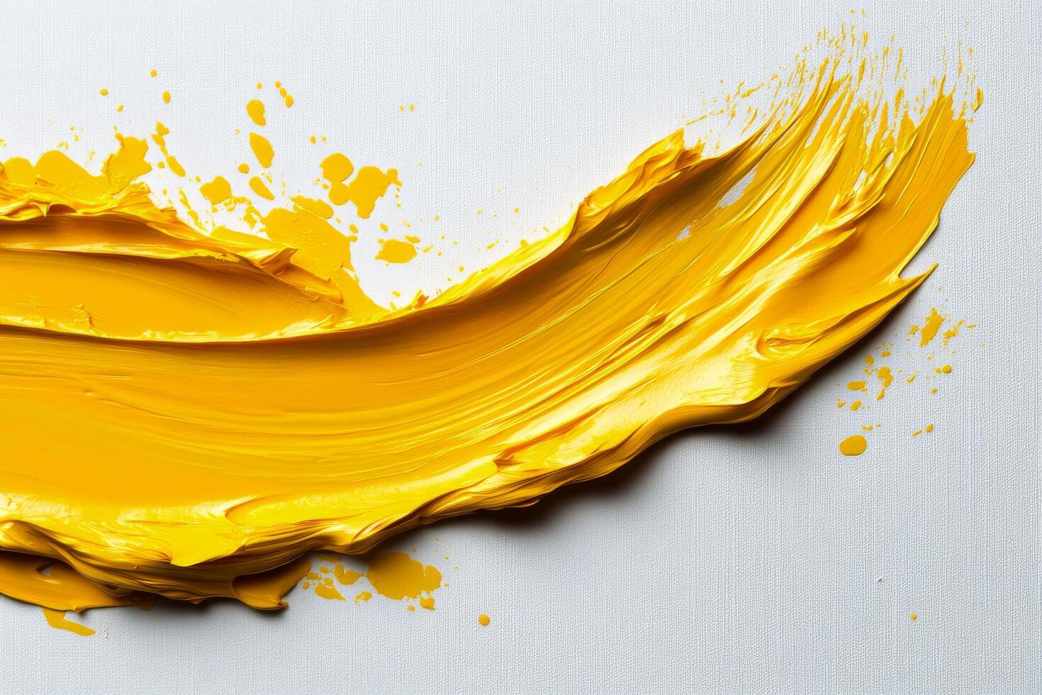 A yellow paint splashed on a white surface photo