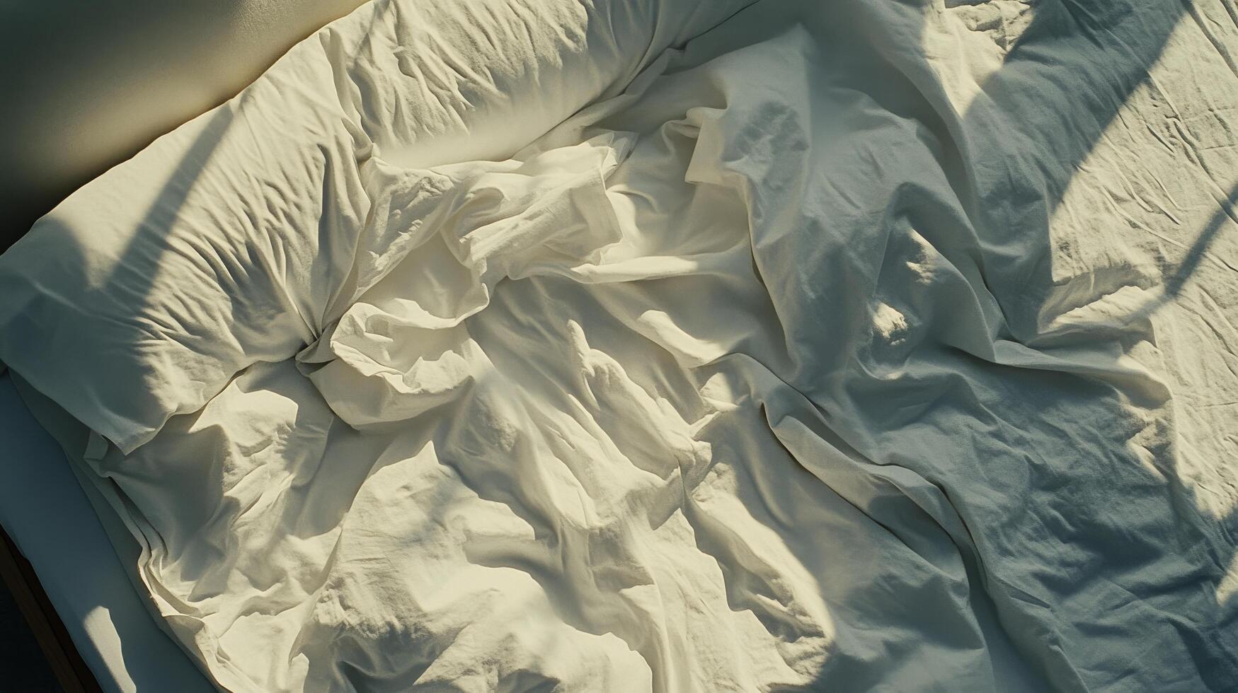 A bed with a white sheet photo