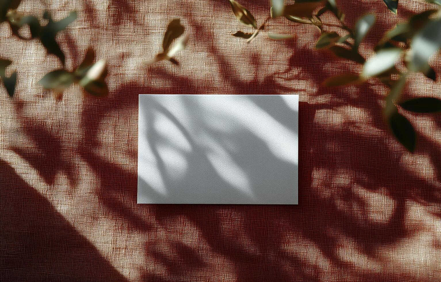A square of paper on a table with leaves photo