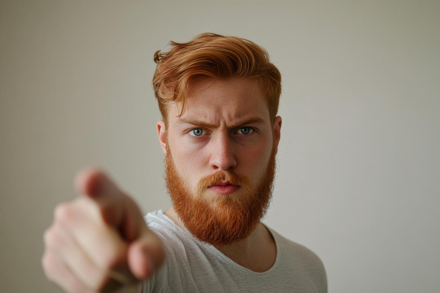 A man with a red beard pointing at something photo