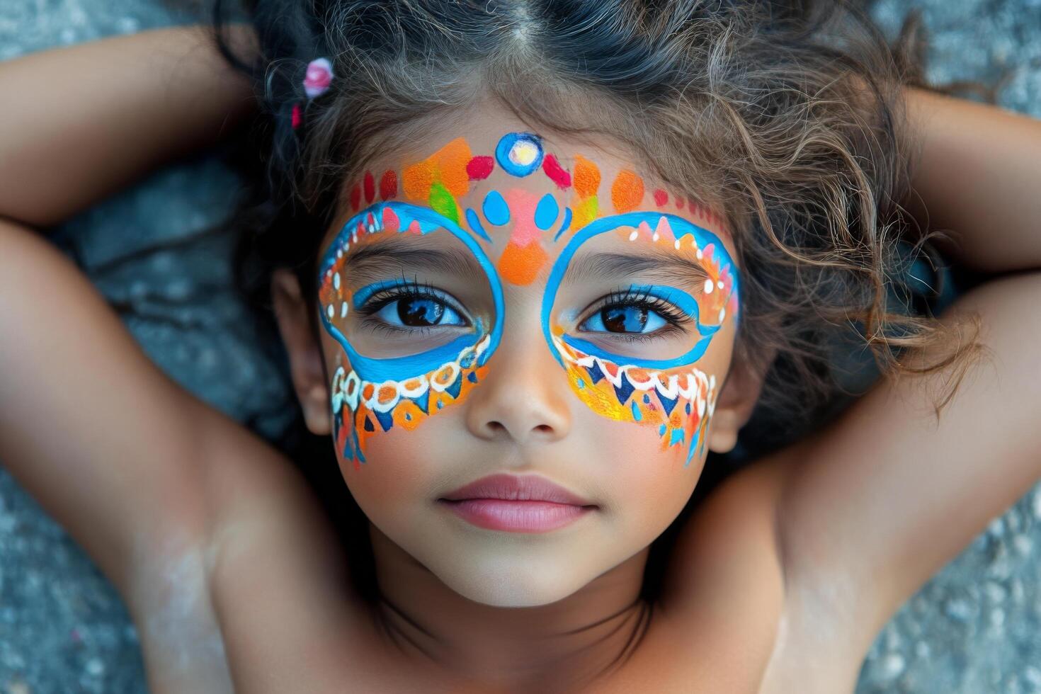 A young girl with a colorful face paint photo