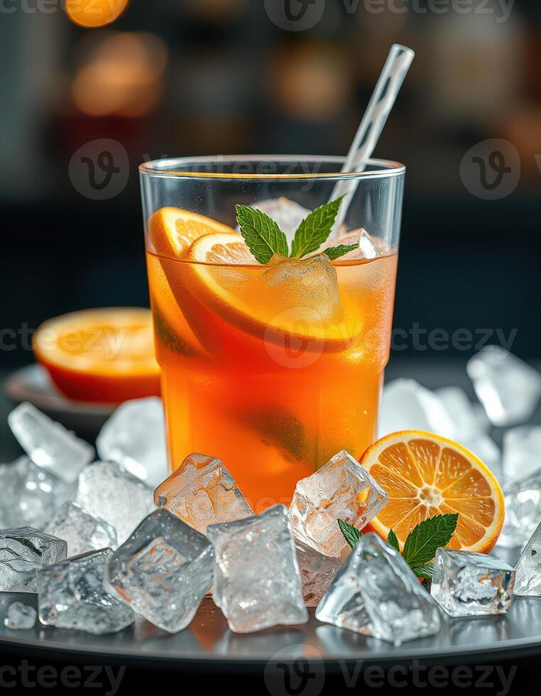Refreshing citrus drink served with ice, garnished with mint leaves and orange slices in a vibrant setting photo