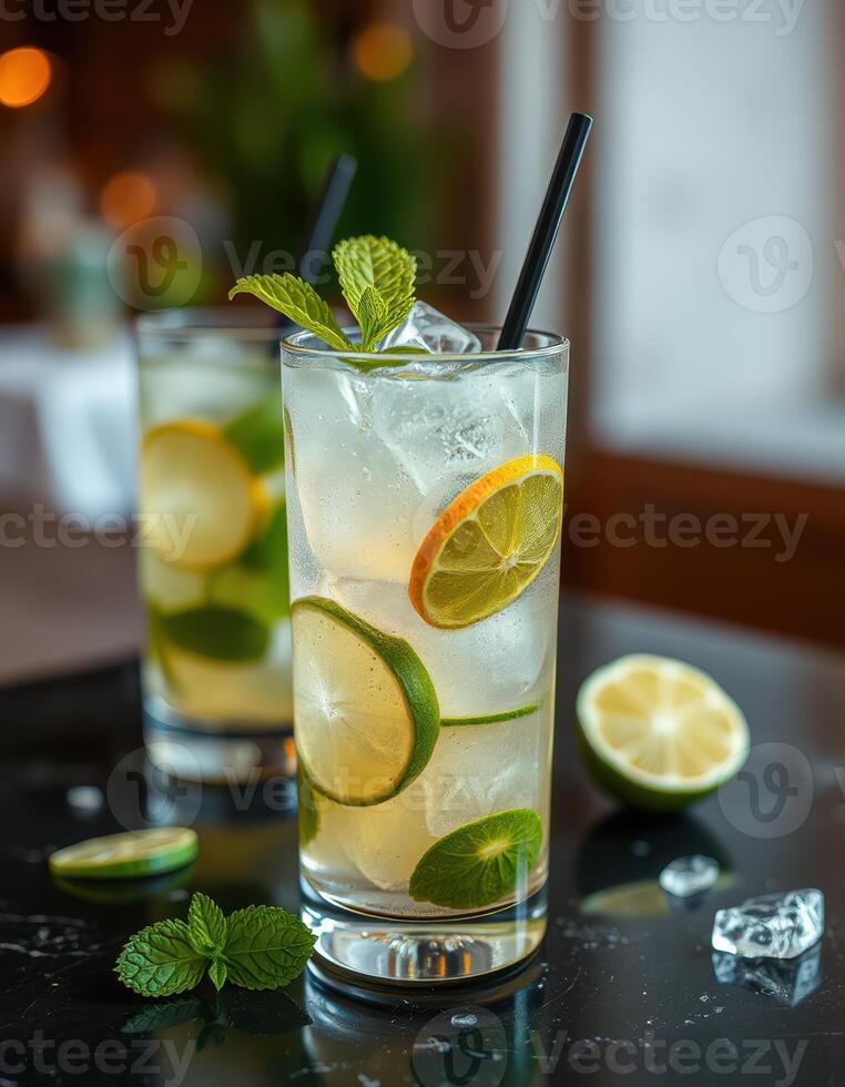 Refreshing lime and mint cocktails served in tall glasses at a trendy bar during a vibrant evening gathering photo