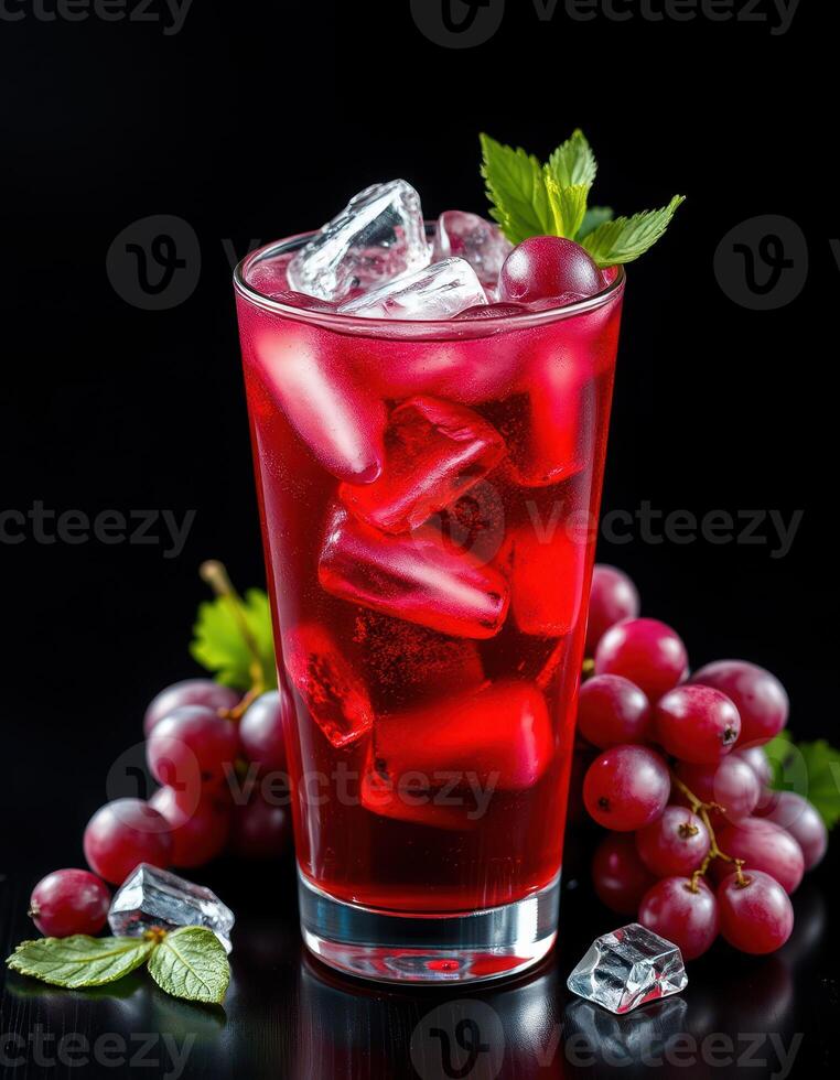 Refreshing red beverage with ice and grapes presented on a dark surface photo