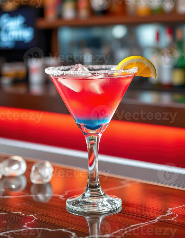 Colorful cocktail served in a stylish glass at a vibrant bar setting during evening hours photo