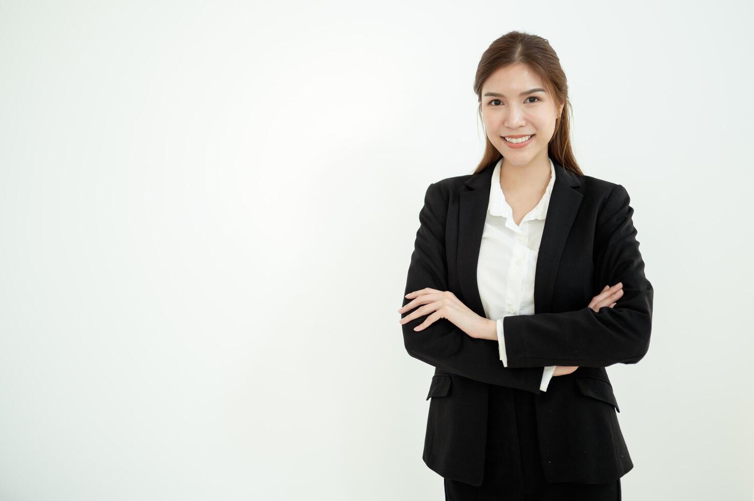 Professional Woman in Black Suit Stands Confidently Against a Plain Background photo