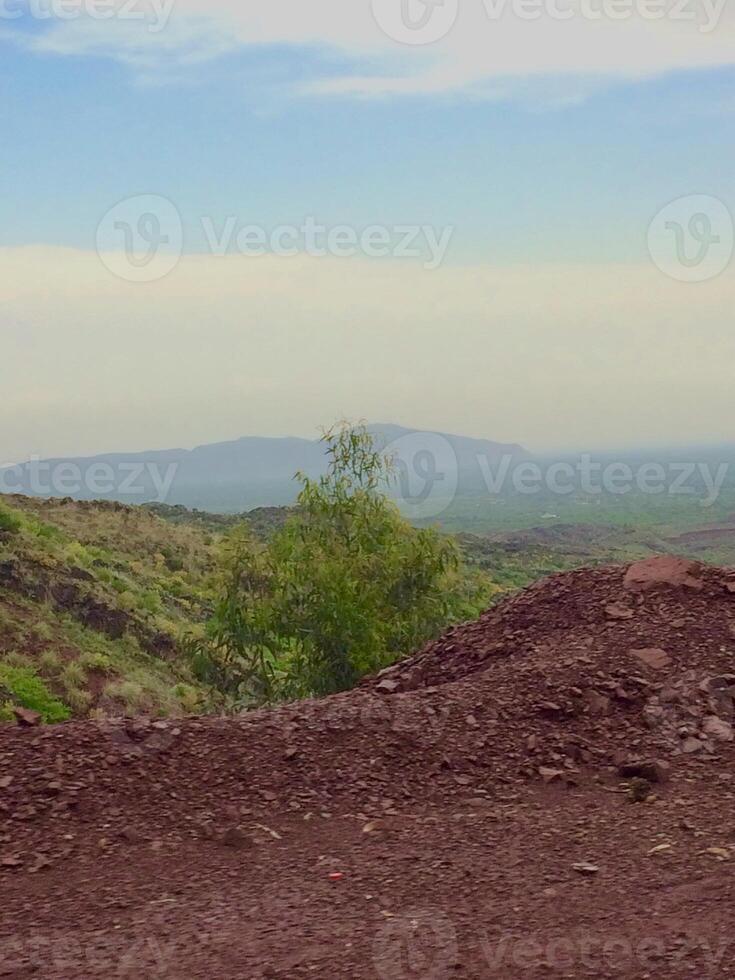 A dirt road with a mountain in the background photo
