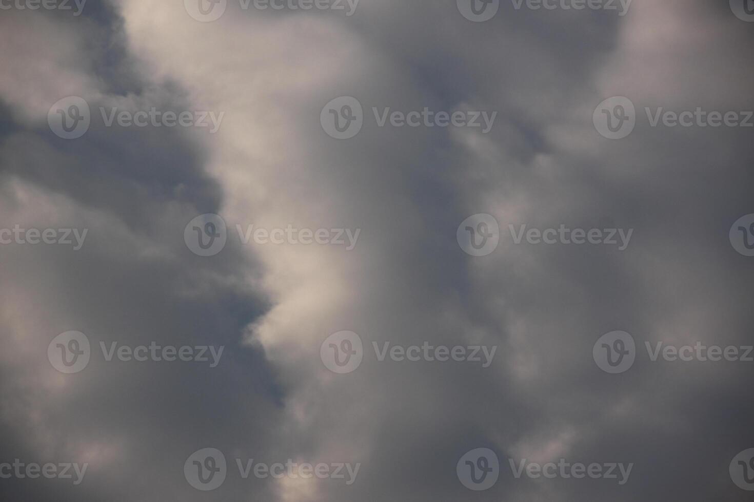 A plane flying through the clouds with a dark sky photo