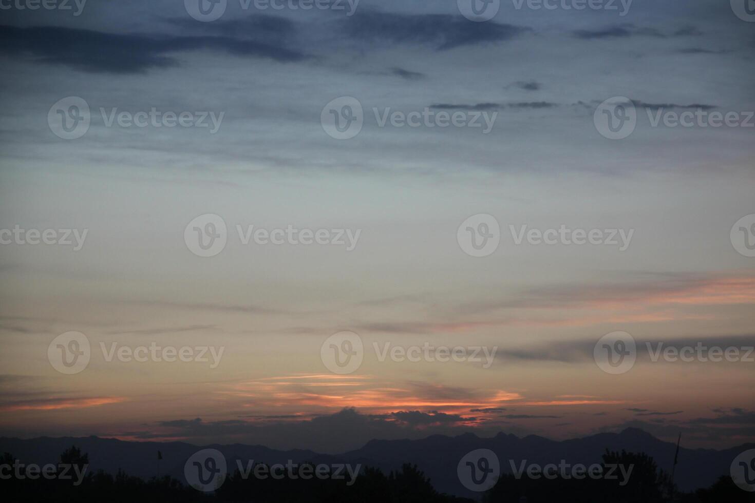 A plane flying in the sky at sunset photo