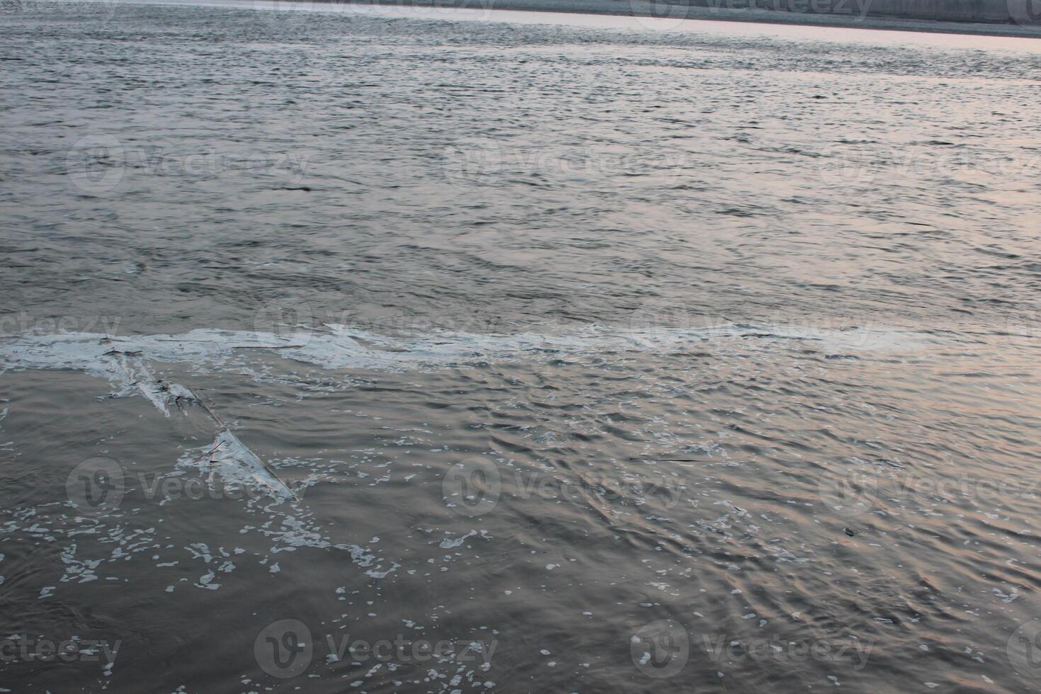 A person is flying a kite in the water photo