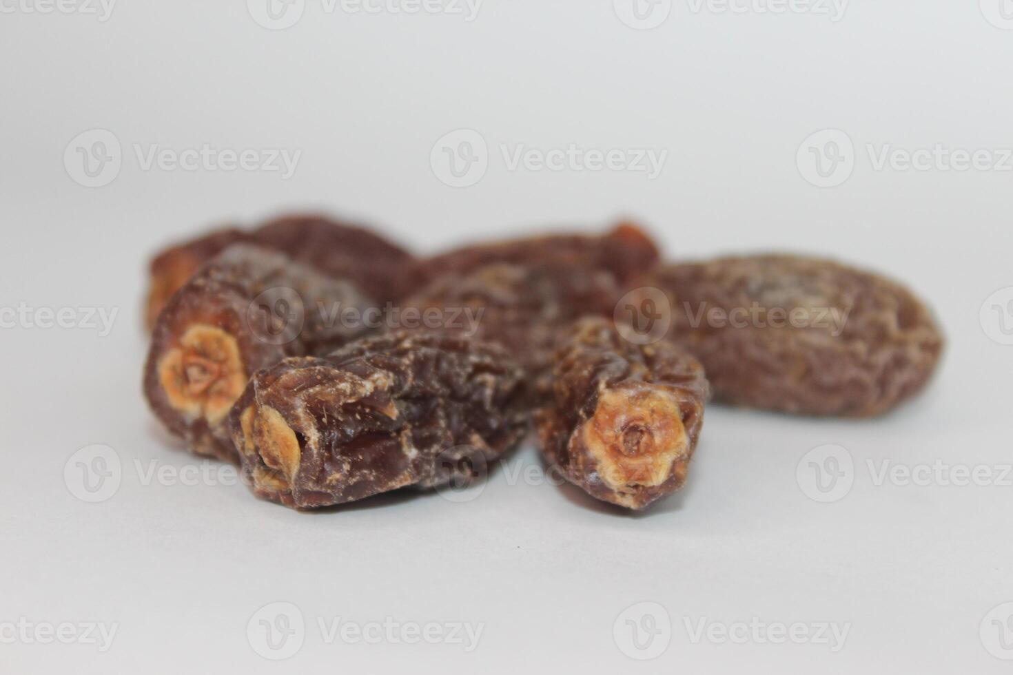 A close up of dried dates on a white background photo
