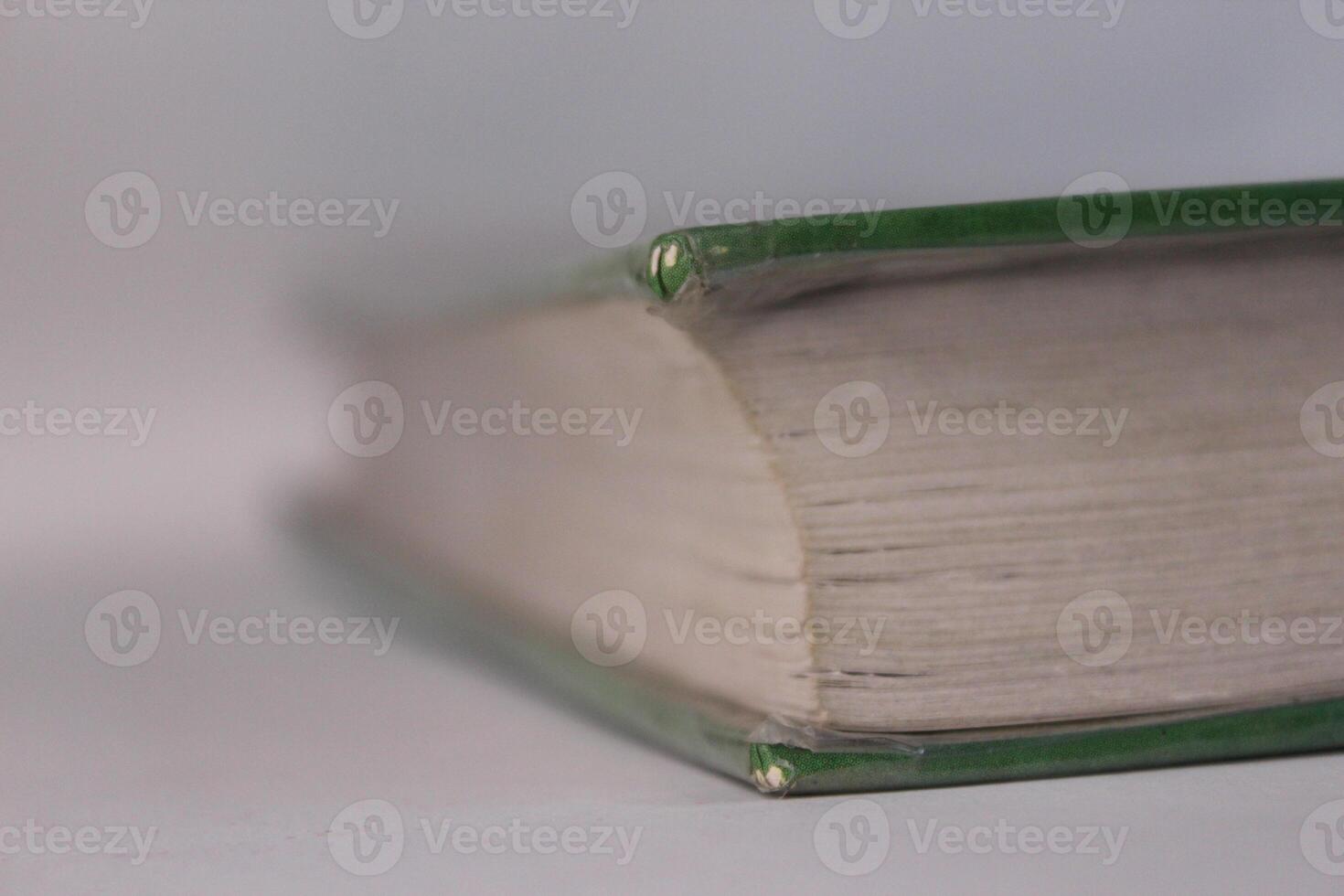 A close up of a book with a green cover photo
