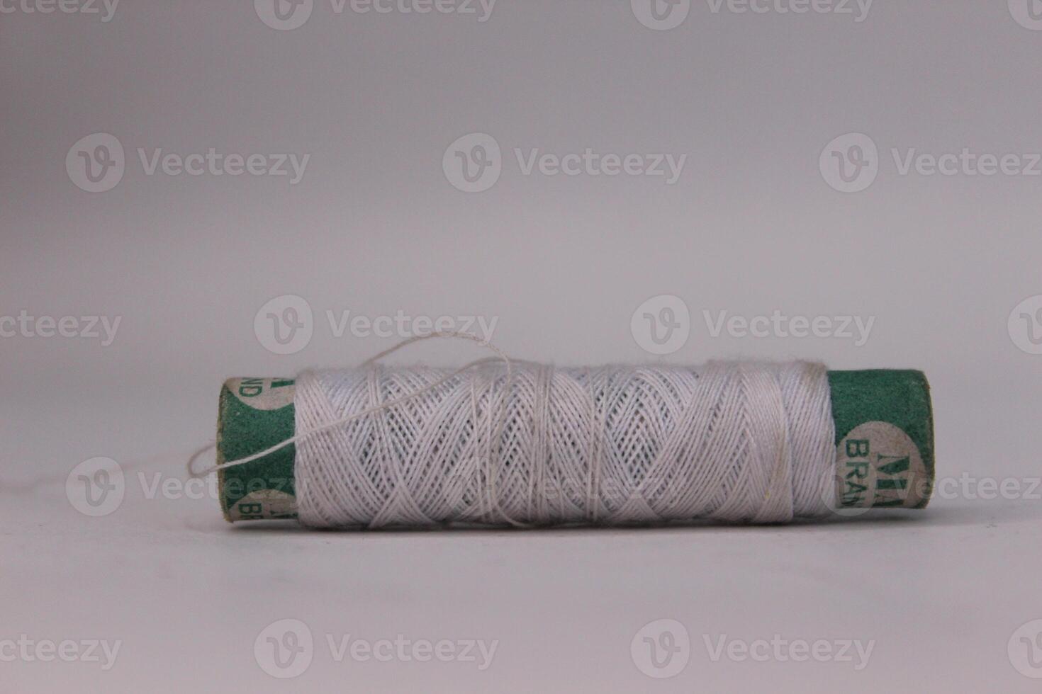 A spool of white thread on a table photo