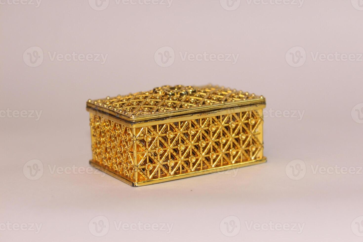 A gold box with intricate design on white background photo