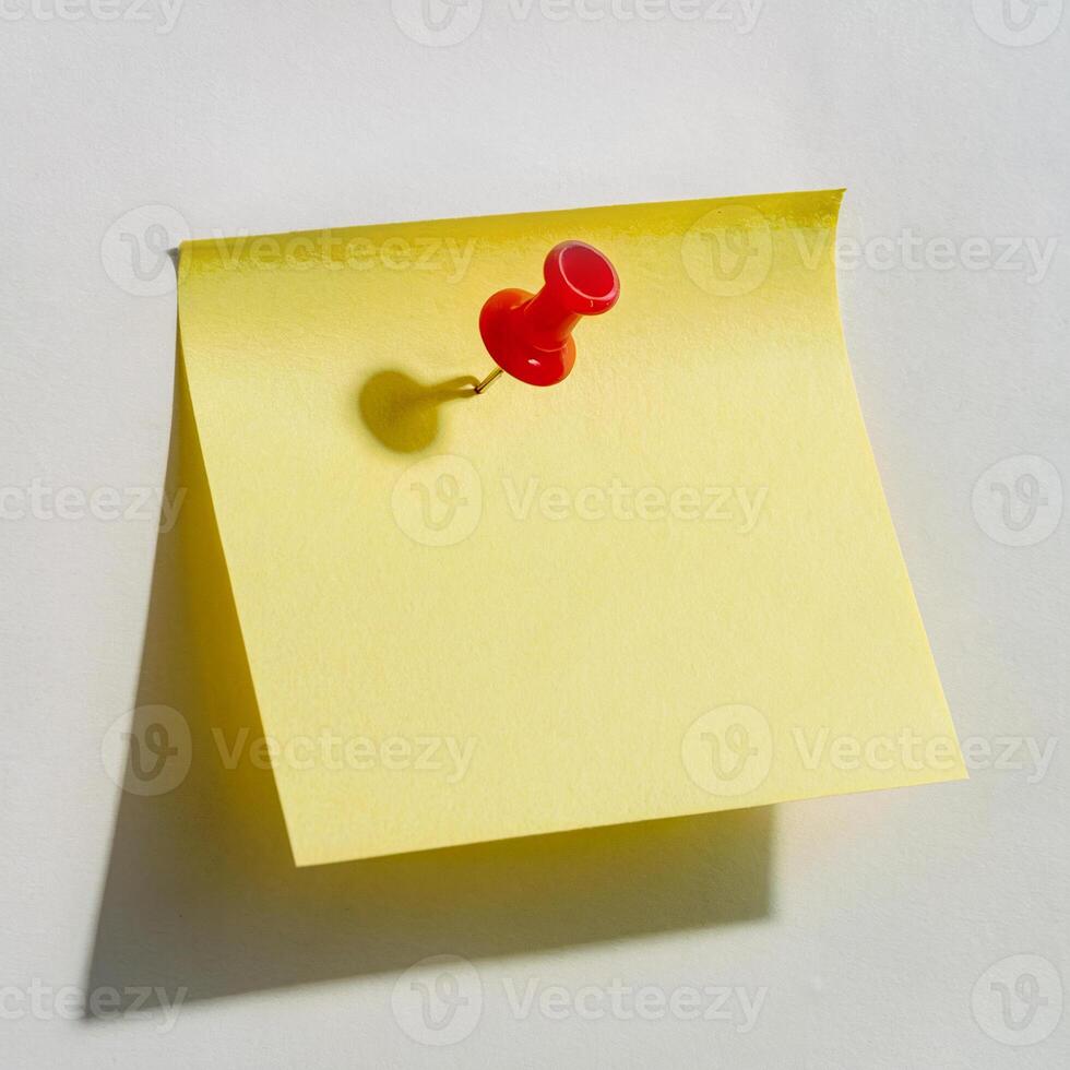 A yellow sticky note pinned to a white wall photo