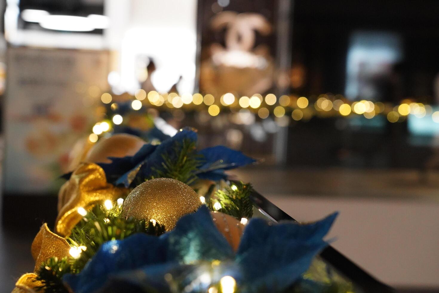 a blue and gold christmas decoration on a railing photo