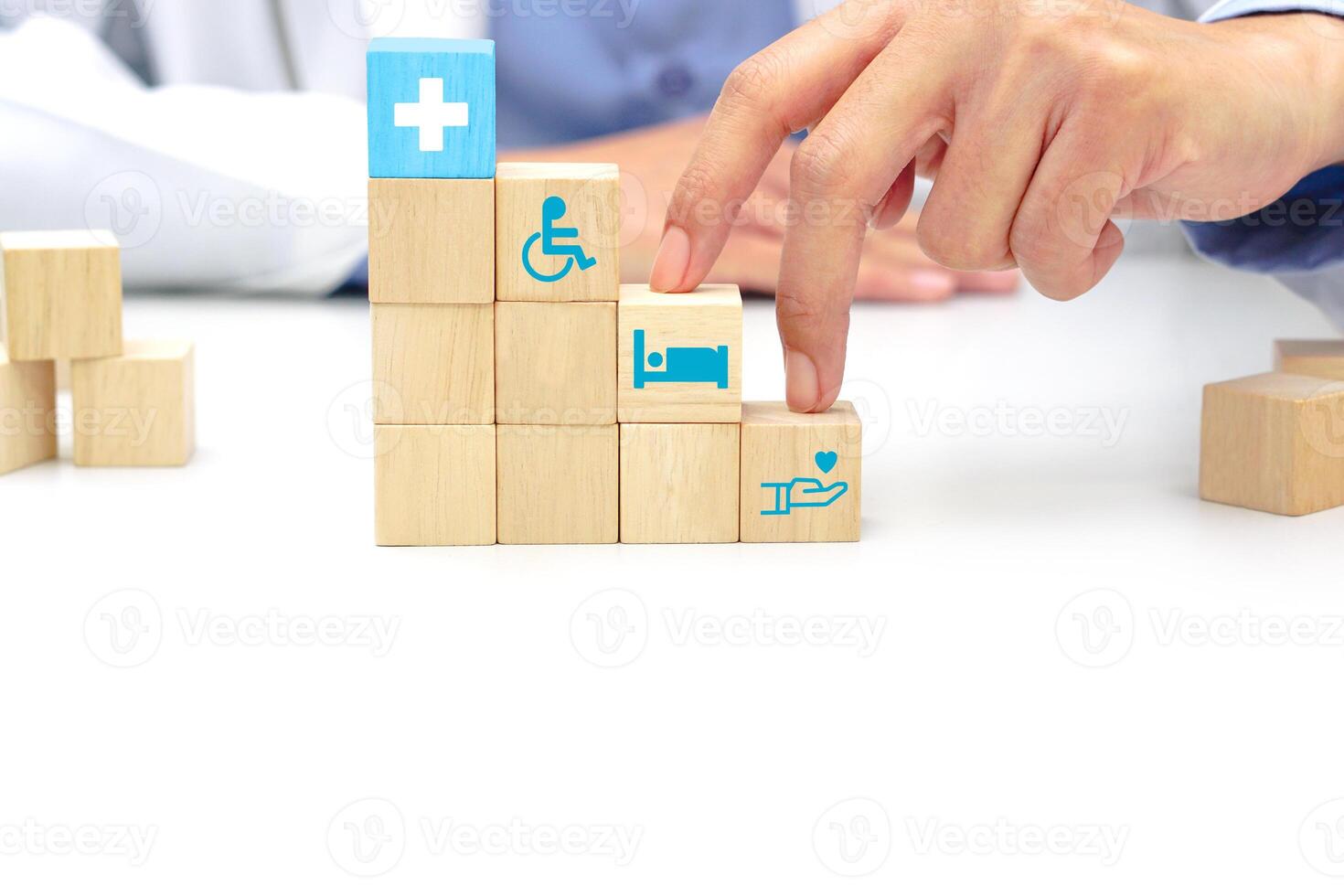 Two fingers of doctor is walking up stairs wooden blocks with medical symbol icons. Concept of Success, progress, medical and growth. photo