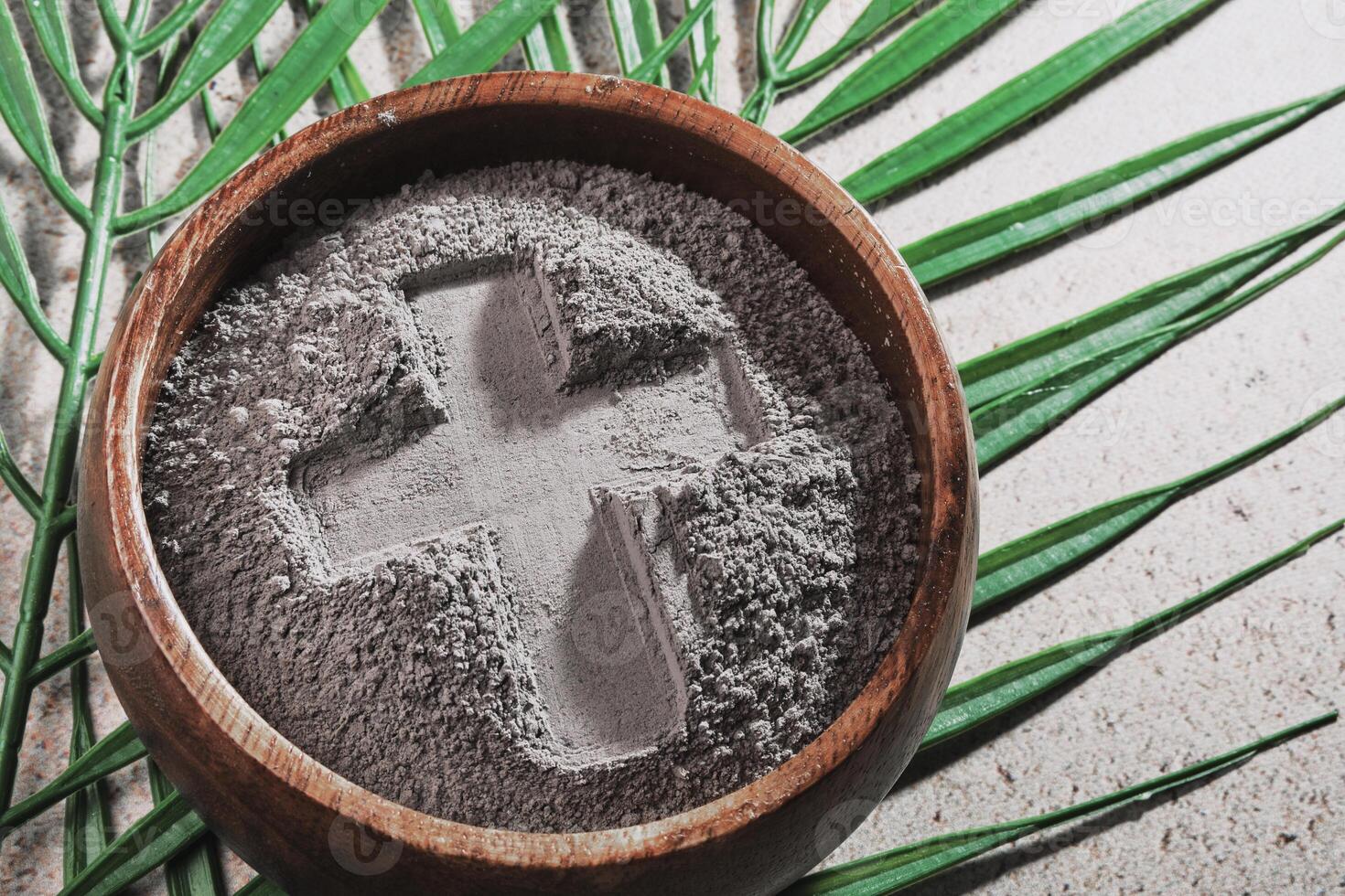 Ash Wednesday. Cross in ashes and palm leaf photo