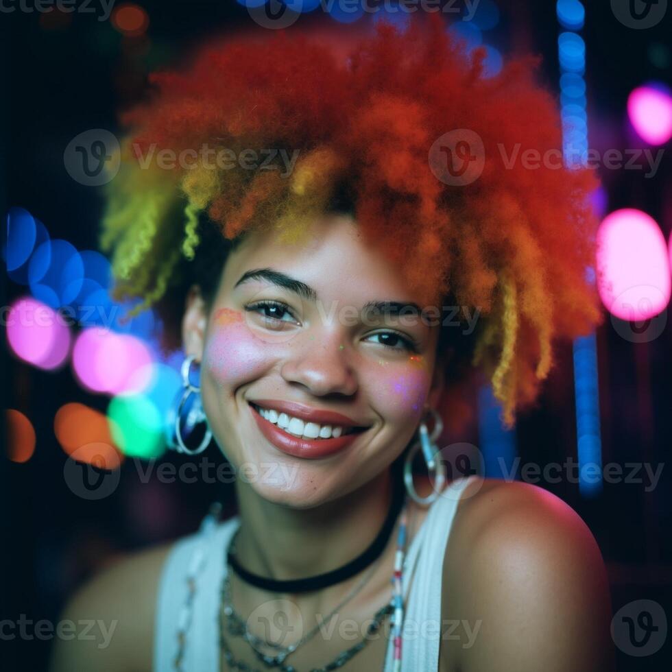 A woman with red, yellow, and orange hair is smiling photo