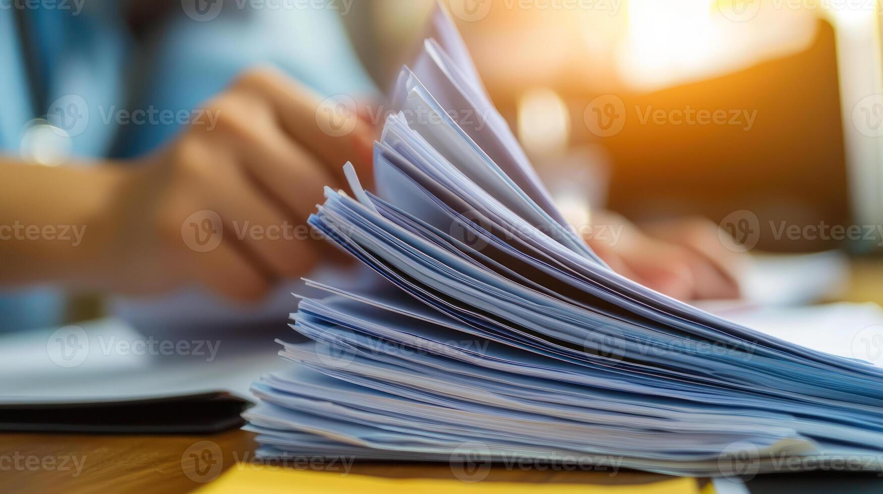 Focused team reviewing documents with natural light illuminating workspace photo