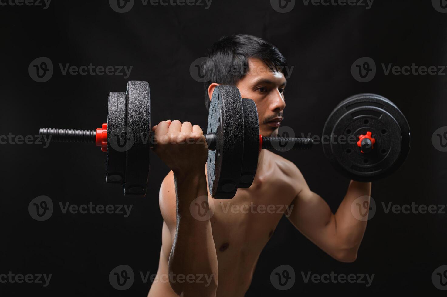 Focused Man Lifting Dumbbells for Strength and Fitness Training photo