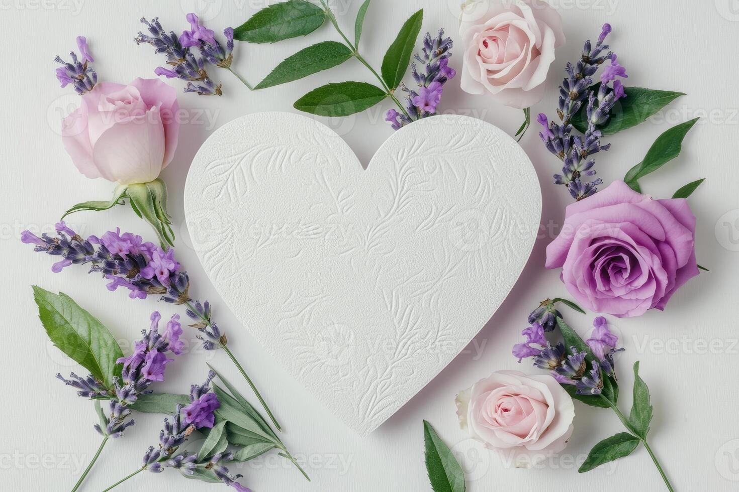 Heart-shaped card surrounded by delicate lavender and pink roses on a clean white backdrop photo