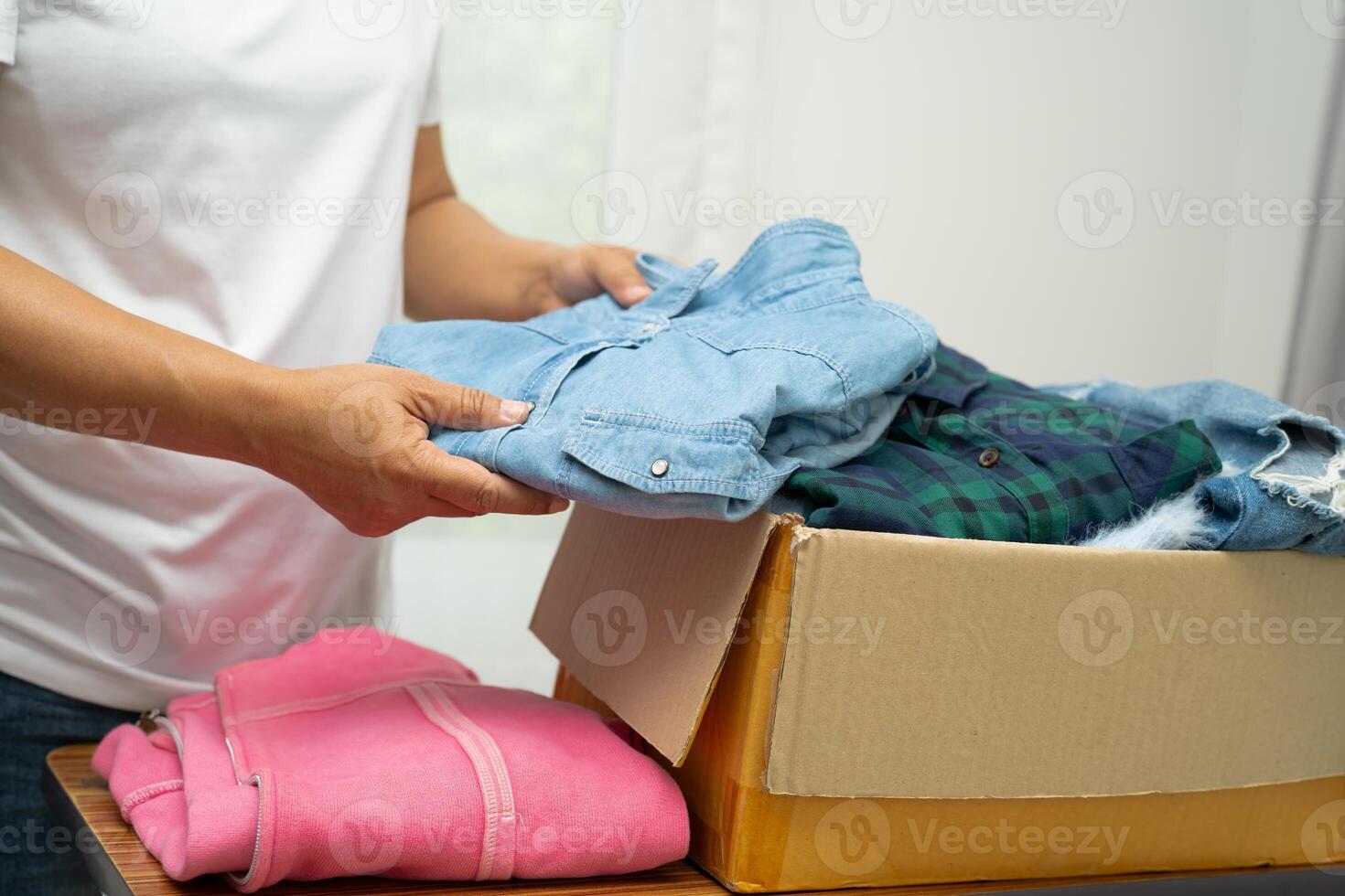 Donation box with used clothes at home to support help photo