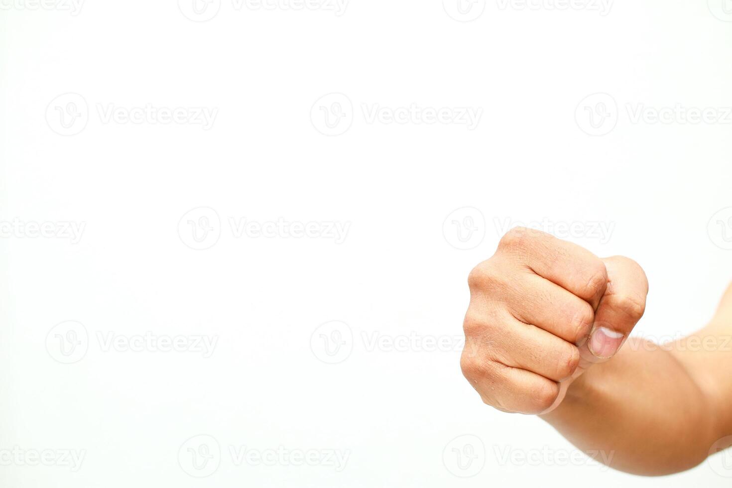 A clenched human fist on a stark white background displays aggression or determination photo