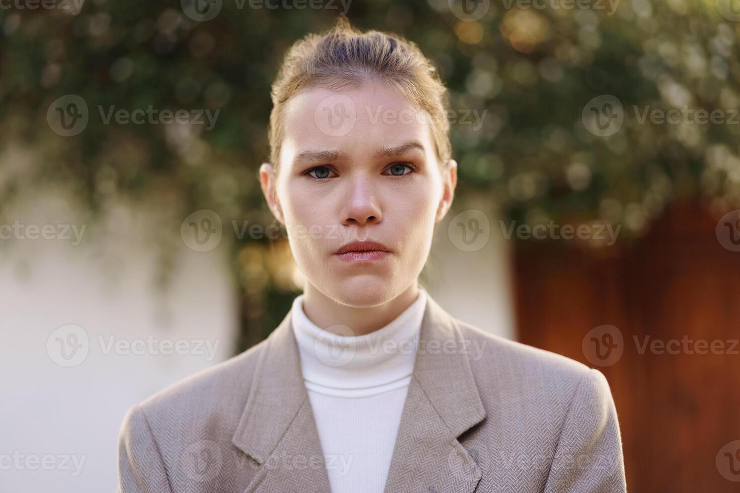 A Confident Young Woman Dressed in Stylish Business Attire Poses Outdoors to Impress photo
